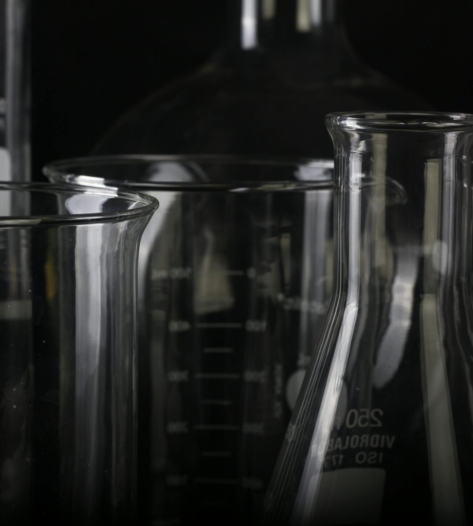 A detailed close-up of various transparent laboratory glassware used in scientific experiments.